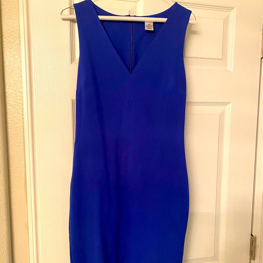 Knee length, sleeveless, v-neck royal blue dress with slit in front.